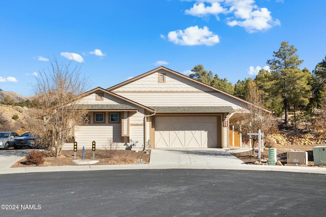 3008 E Cold Springs Trl, Flagstaff, AZ 86004 - view of front facade with a garage, driveway, and roof with shingles