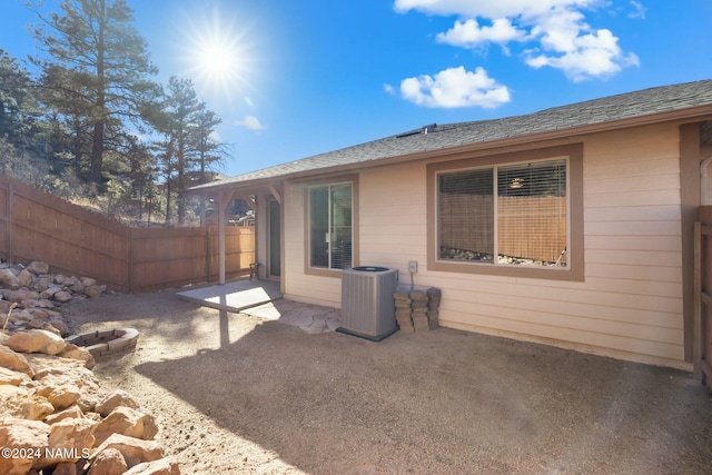 3008 E Cold Springs Trl, Flagstaff, AZ 86004 - rear view of house with central AC, fence, a patio, and a shingled roof