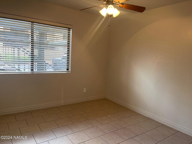 3200 S Litzler Dr Unit 8, Flagstaff, AZ 86005 - empty room with a ceiling fan, baseboards, and light tile patterned floors