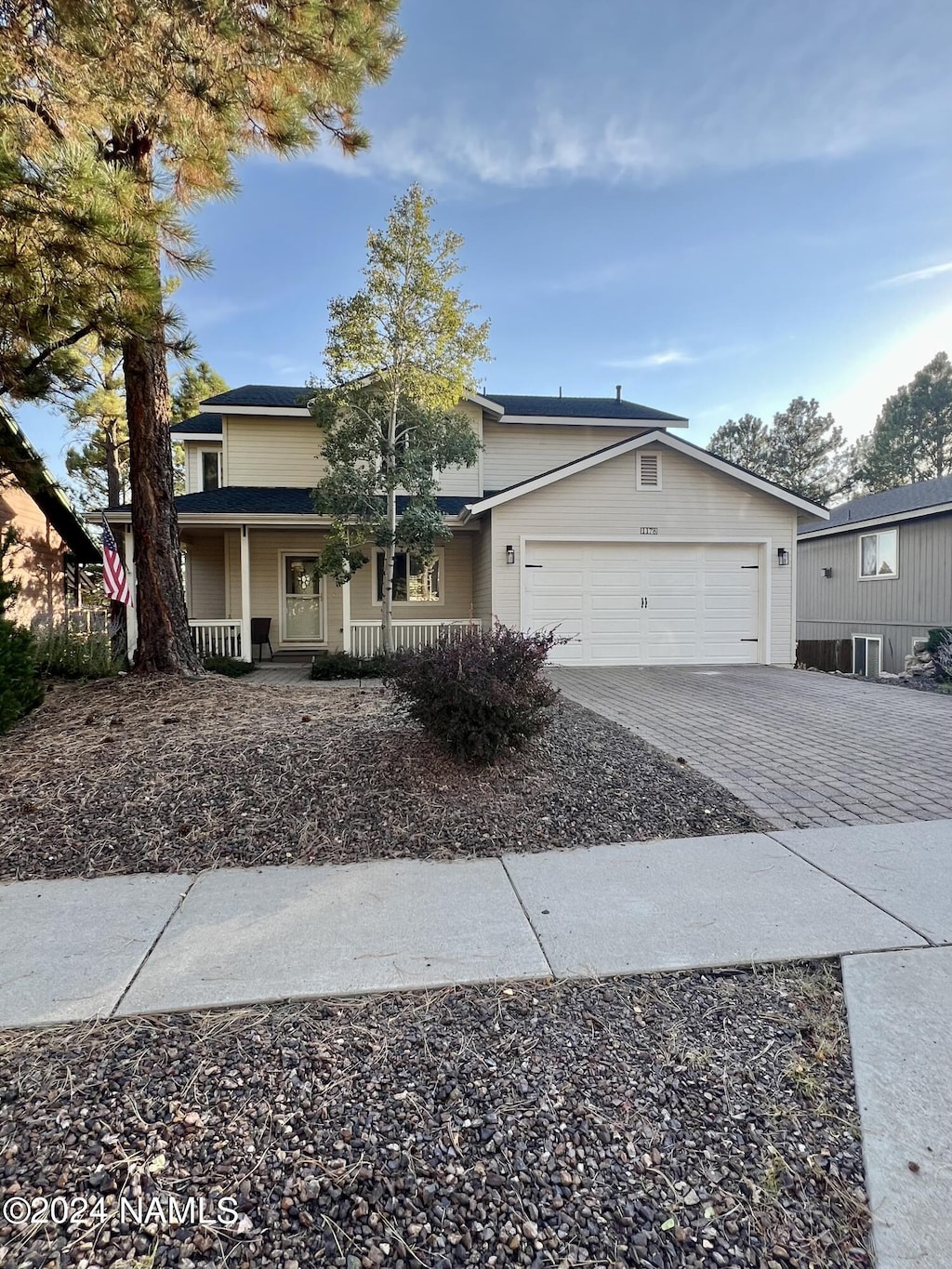 view of front of house featuring a garage and a porch