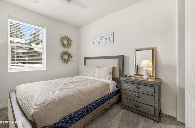 carpeted bedroom with ceiling fan, visible vents, and baseboards