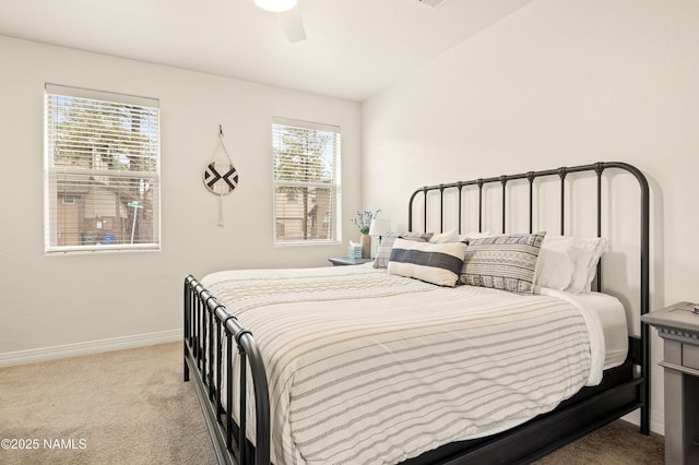 bedroom with lofted ceiling, a ceiling fan, baseboards, and carpet flooring