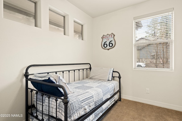 carpeted bedroom featuring baseboards