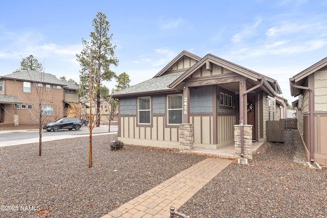 view of front of property featuring board and batten siding and roof with shingles