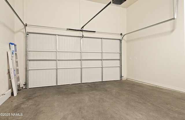 garage with baseboards and a garage door opener