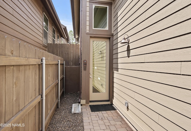 doorway to property featuring fence