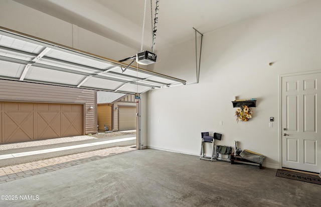 garage with baseboards and a garage door opener