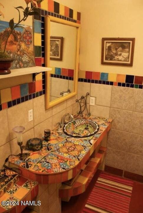 bathroom with tile walls