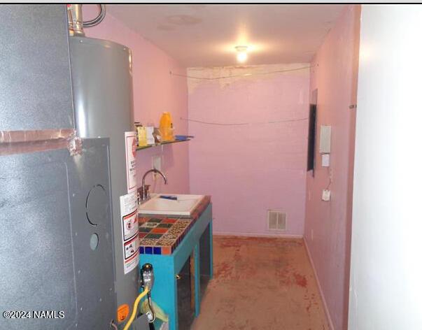 interior space featuring sink and water heater