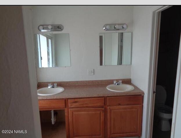 bathroom featuring vanity and toilet