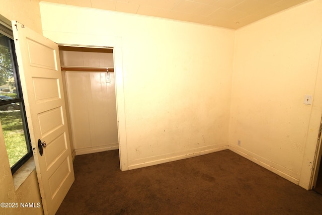417, 429 W Sheridan Ave, Williams, AZ 86046 - unfurnished bedroom featuring dark carpet, baseboards, and ornamental molding