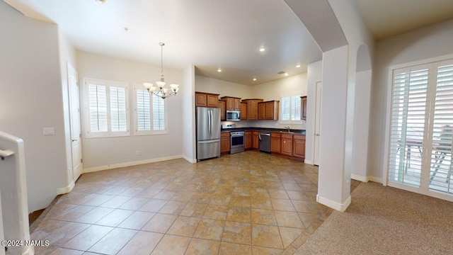 kitchen featuring stainless steel appliances, an inviting chandelier, sink, hanging light fixtures, and light tile patterned flooring