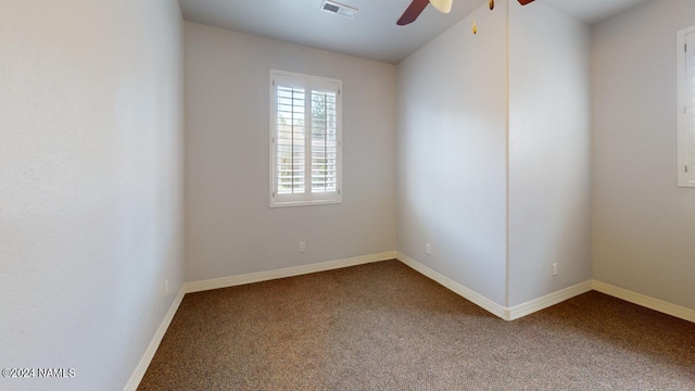 unfurnished room with ceiling fan and carpet