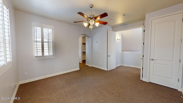 empty room featuring carpet flooring and ceiling fan