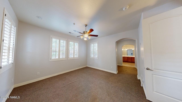 empty room featuring carpet flooring and ceiling fan