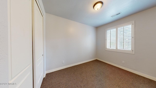 unfurnished bedroom with a closet and carpet