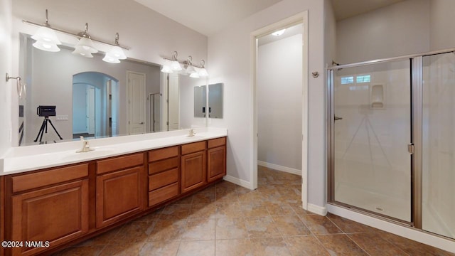 bathroom featuring an enclosed shower and vanity