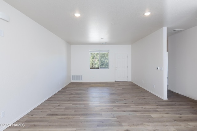 unfurnished room with light hardwood / wood-style flooring