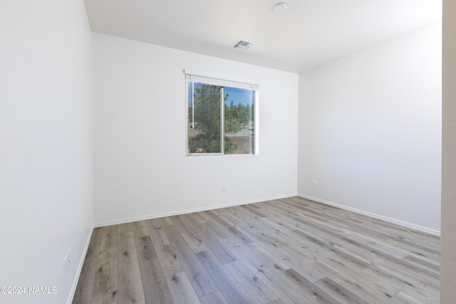 spare room with light hardwood / wood-style flooring