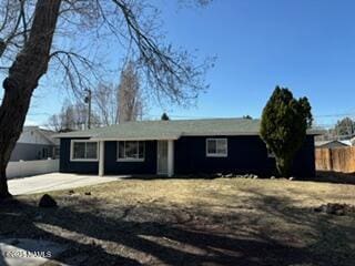 ranch-style home with fence