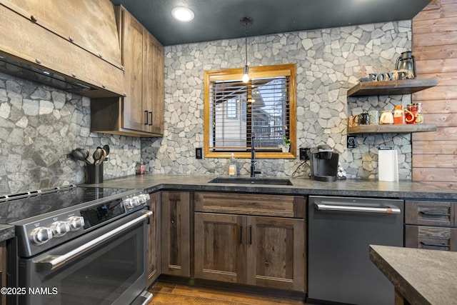 kitchen featuring range hood, dark countertops, a sink, dishwasher, and stainless steel electric range