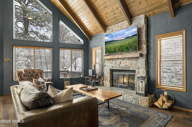 living room with a textured wall, hardwood / wood-style flooring, wood ceiling, a stone fireplace, and beam ceiling