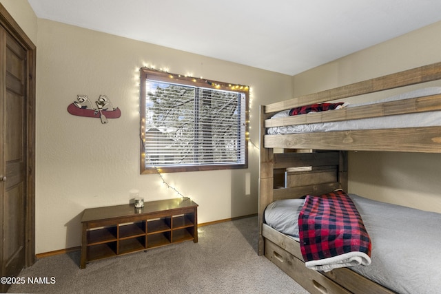 carpeted bedroom featuring baseboards