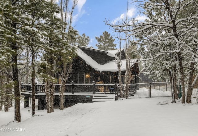 view of snow covered exterior featuring fence