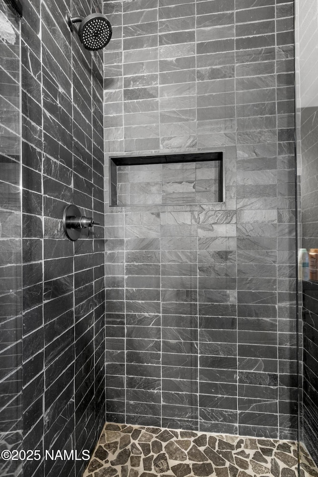 full bath featuring a tile shower