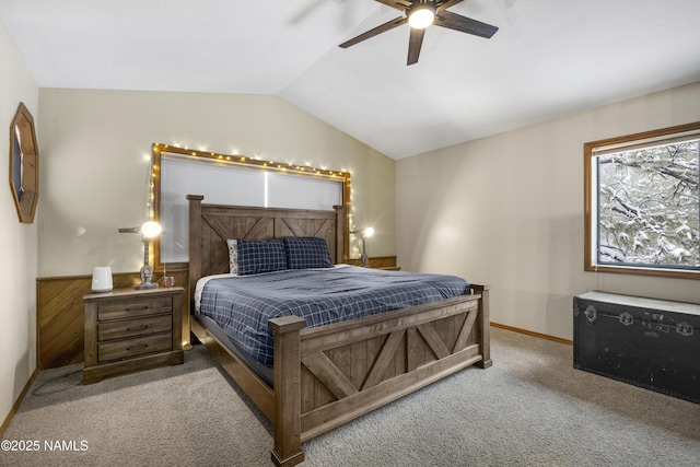 bedroom with ceiling fan, vaulted ceiling, and carpet flooring