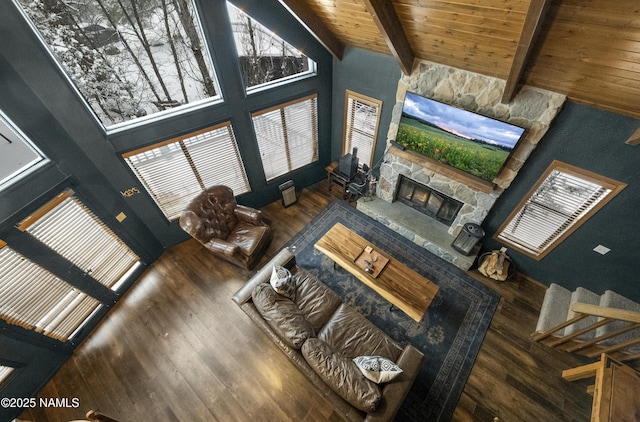 living room with high vaulted ceiling, wooden ceiling, a fireplace, wood finished floors, and beam ceiling