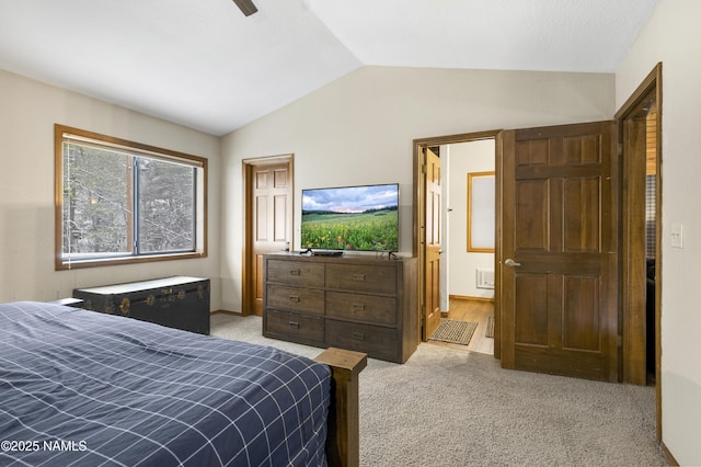 bedroom featuring lofted ceiling and light carpet