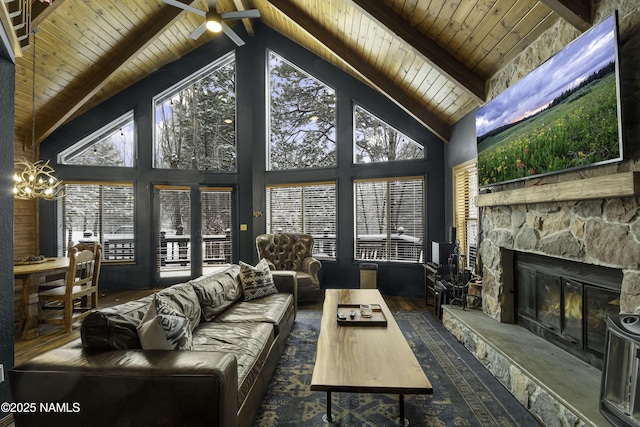 living area with beam ceiling, a stone fireplace, wood finished floors, high vaulted ceiling, and wooden ceiling