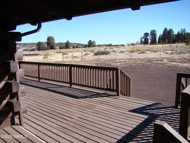 wooden deck with a rural view