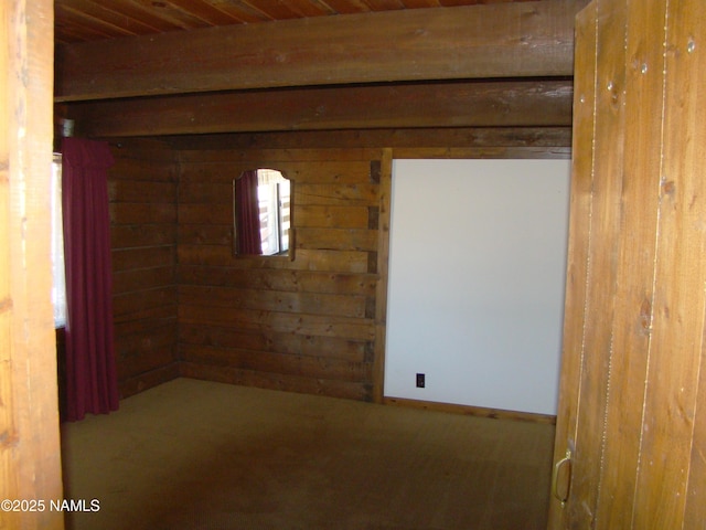 unfurnished room with carpet floors and wooden ceiling