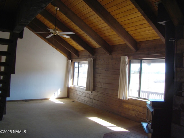 interior space with wooden walls, vaulted ceiling with beams, carpet, ceiling fan, and wooden ceiling