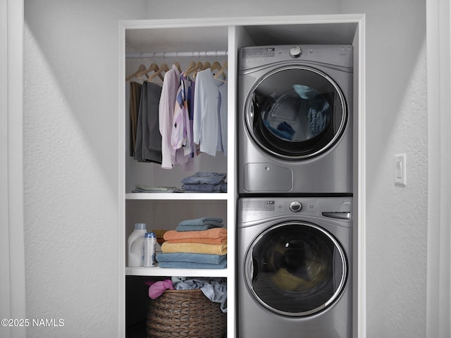 clothes washing area with stacked washer and dryer