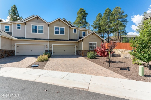 3223 S Beringer Ln, Flagstaff, AZ 86005 - view of front facade featuring stone siding, decorative driveway, board and batten siding, and an attached garage