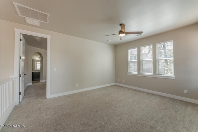 3223 S Beringer Ln, Flagstaff, AZ 86005 - empty room with ceiling fan, healthy amount of natural light, light colored carpet, and arched walkways