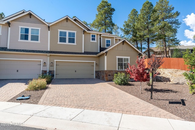 3223 S Beringer Ln, Flagstaff, AZ 86005 - view of front of house with board and batten siding, decorative driveway, stone siding, and an attached garage