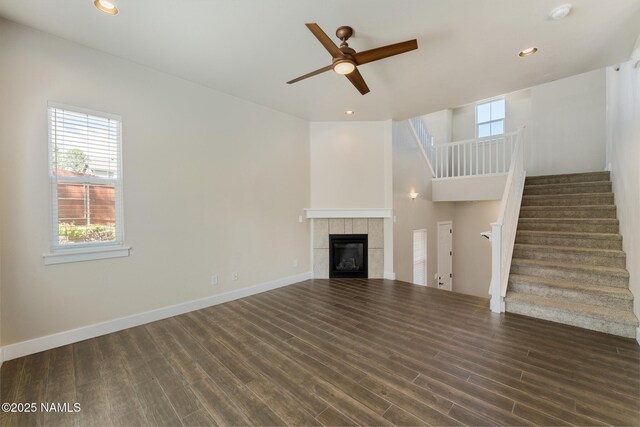 3223 S Beringer Ln, Flagstaff, AZ 86005 - unfurnished living room with a tiled fireplace, a ceiling fan, stairway, wood finished floors, and recessed lighting