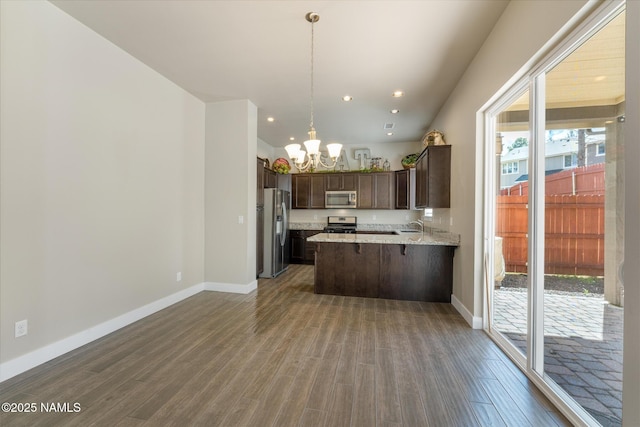 3223 S Beringer Ln, Flagstaff, AZ 86005 - kitchen featuring stainless steel appliances, dark brown cabinetry, a chandelier, wood finished floors, and a peninsula