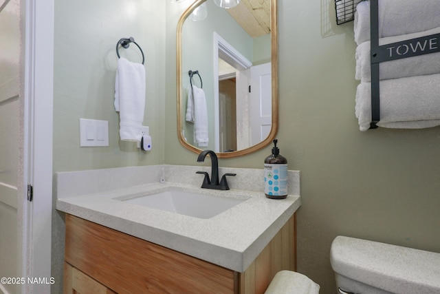 bathroom with toilet and vanity