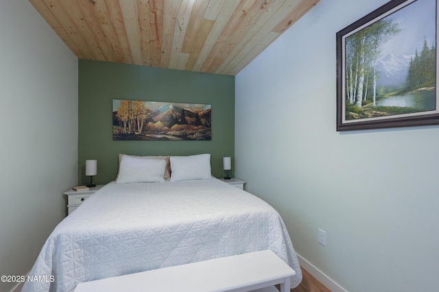 bedroom with hardwood / wood-style flooring and wood ceiling