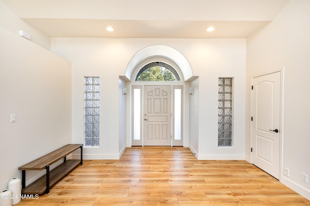 foyer entrance featuring light wood-type flooring, baseboards, and recessed lighting