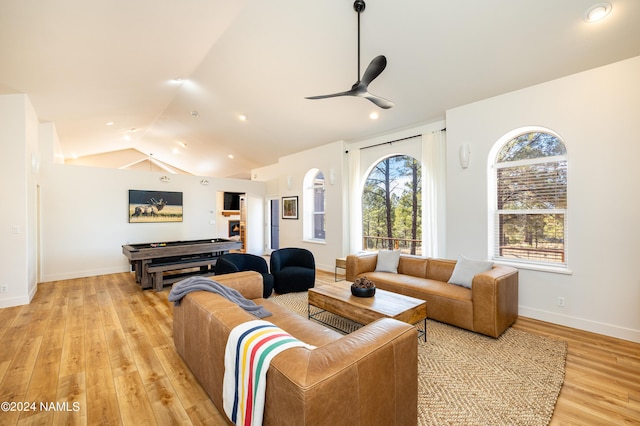 living room with light wood finished floors, baseboards, a ceiling fan, vaulted ceiling, and recessed lighting