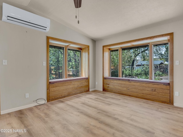 415 W Apache Rd, Flagstaff, AZ 86001 - unfurnished room featuring a wall mounted air conditioner, plenty of natural light, light wood finished floors, and baseboards
