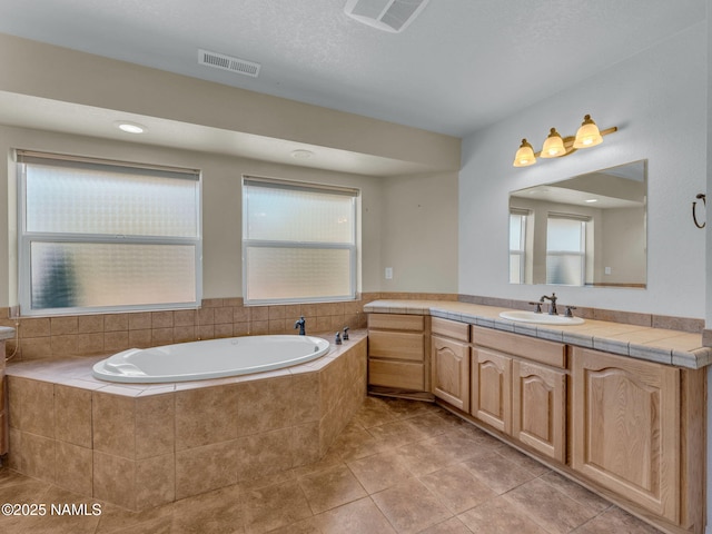 415 W Apache Rd, Flagstaff, AZ 86001 - full bathroom with vanity, a bath, plenty of natural light, and tile patterned floors