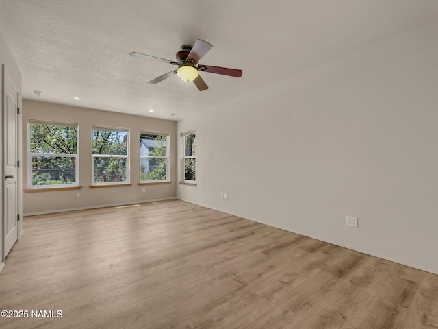 415 W Apache Rd, Flagstaff, AZ 86001 - spare room with light wood-type flooring, plenty of natural light, ceiling fan, and a textured ceiling