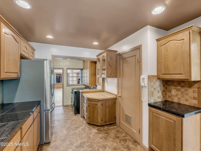 415 W Apache Rd, Flagstaff, AZ 86001 - kitchen featuring tile countertops, glass insert cabinets, backsplash, freestanding refrigerator, and recessed lighting